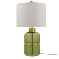 a green glass table lamp with a white shade