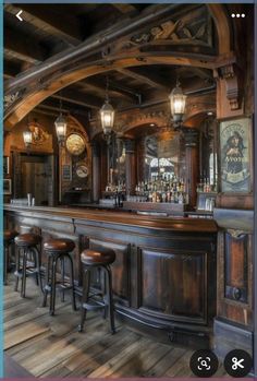 an image of a bar with stools in the middle and lights on above it