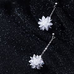 This pair of snow flower dangle drop earrings features a beautiful snowflake / lotus flower in white crystal with dangle chain made of solid 925 sterling silver with platinum platting. Add this pair of white flower dangle drop earrings to your everyday fine jewelry collection or as gift for your love one this Christmas holiday season. Jewelry Care: See more information about how to care for your jewelry here. Shipping Policy: Orders will be shipped within 1-3 business days. Economy shipping will Winter Inspired Jewelry, White Sterling Silver Flower Earrings For Party, Silver Crystal Flower Earrings For Gift, Snow Earrings, Christmas Gift Earrings, Snowflake Jewelry, Snow Flower, Snowflake Earrings, Dainty Chain