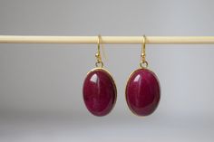 Red Jade Earrings Gold, Oval Gemstone Hanging Earrings, Wine Red Earrings, Dangle Drop Stone Earrings For Women, Jade Jewelry, Gift For Her. ⭐ Handmade beautiful Red Jade gold oval earrings. ⭐ Materials used:-   Earrings  ✧ High quality gold plated stainless steel earrings hooks. ✧ 13mm x 18mm high quality gold plated stainless steel oval pendant. ✧ Semiprecious gemstone Red (wine red) Jade, jewelry glue. ⭐ Matching necklace https://www.etsy.com/listing/1476504603/burgundy-red-jade-necklace-wine Red Oval Ruby Earrings, Oval Red Ruby Earrings, Red Oval Gemstone Earrings, Oval Ruby Earrings Gift, Red Oval Earrings For Pierced Ears, Red Earrings Dangle, Gold Oval Earrings, Red Jade, Jade Earrings