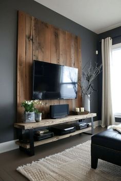 a living room with a large television on the wall