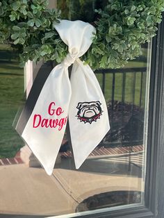 two white bags with the words go dawg on them hanging from a door