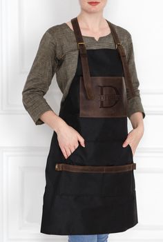 a woman wearing an apron with the letter d on it