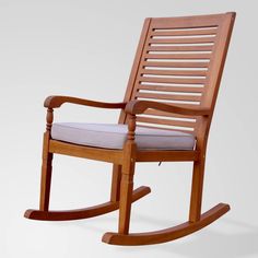 a wooden rocking chair with a cushion on it