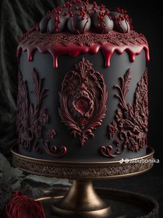 a cake with red icing on it sitting on top of a metal stand next to a rose