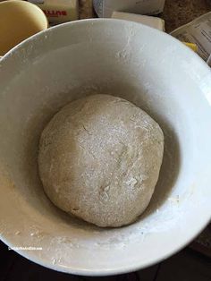 a ball of dough in a white bowl