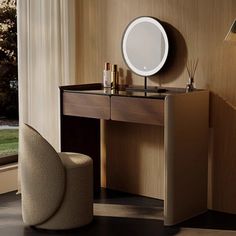 a dressing table with a mirror on it next to a chair in front of a window