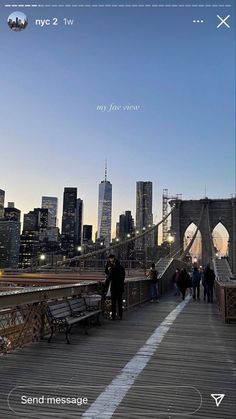 people walking across a bridge in the city