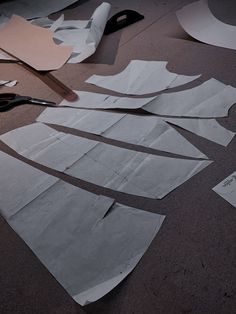 cut out pieces of paper sitting on top of a table