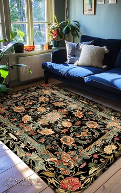 a living room with a blue couch and rug