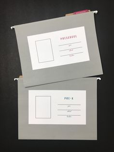 two envelopes with stamps on them are sitting next to each other in front of a black background