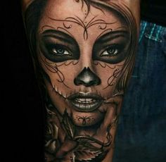 a woman's face with black and white makeup on her arm, in the style of day of the dead