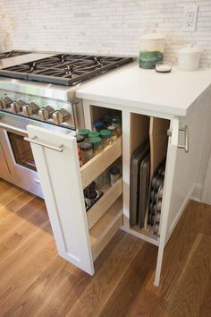 an open cabinet in the middle of a kitchen