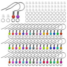 a bunch of different colored pins and hooks on a white background with clippings