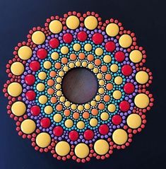 a circular object made out of circles and dots on a black surface with blue background