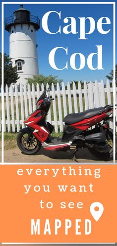 a red scooter parked in front of a white picket fence next to a light house