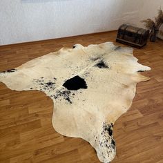 a cowhide rug with black spots on it