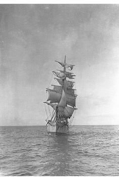 an old black and white photo of a sailboat in the middle of the ocean