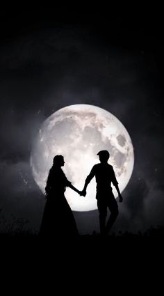 two people holding hands in front of a full moon