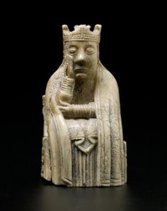 a white statue with a crown on it's head and hands in front of a black background