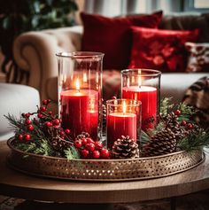 a coffee table styled for Christmas - with antique gold tray holding chunky red candles in glass cylindrical holders, with rustic centerpiece from pine cones and winter foliage. - red velvet decorative cushions add the right accent. Ideas Decoracion Navidad, Christmas Coffee Table Decor, Red Christmas Decor, Christmas Candle Decorations, Christmas Decor Inspiration, Christmas Centerpieces Diy, Christmas Decorations Living Room, Christmas Themes Decorations, Christmas Table Settings