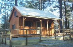 a small wooden cabin in the woods with steps leading up to it's door