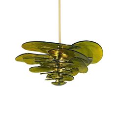 a green glass chandelier hanging from a ceiling fixture with gold colored metal details