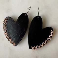 Show your love with these leather heart earrings! Irregular, and uniquely shaped vegetable-tanned leather hearts are accented along the sides with leather cord stitching. Surgical steel ear wires. Large size hangs 2.5" long and measures 1.5" wide; small sizes hangs 2” long and measures 1” wide. Leather Jewelry Making, Handmade Leather Jewelry, Diy Leather Earrings, Idee Cricut, Leather Jewelry Diy, Leather Lacing, Leather Jewels, Leather Craft Projects, Leather Heart