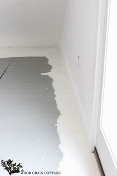 an empty room with white paint on the floor