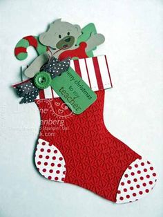 a christmas stocking with a teddy bear on it and a tag attached to the sock