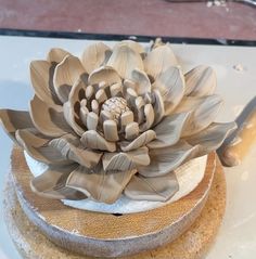 there is a large flower on top of the cake