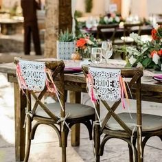 the table is set with chairs and place settings for guests to sit down at it