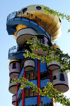 a tall building with many windows and balconies on it's sides, in front of a blue sky