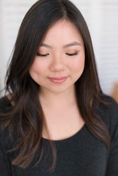 a woman with long dark hair wearing a black shirt