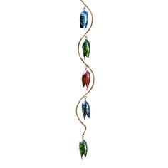 a glass wind chime hanging from a metal rod with three colorful leaves on it