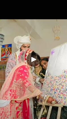 the bride and groom are getting ready to go into their wedding ceremony at home in india