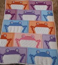 a crocheted blanket with sheeps on it