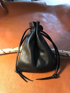 a small black bag sitting on top of a table