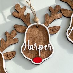 three wooden reindeer ornaments with the word harper hanging from them's ears and nose