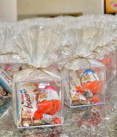 three clear boxes with candy wrapped in plastic