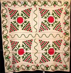 an old quilt with holly and berries on it