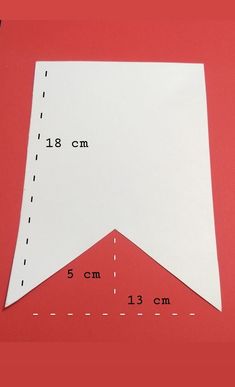 a piece of paper that has been cut in half on top of a red surface