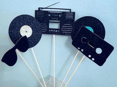 some black and white tape recorders on top of each other with toothpicks sticking out of them