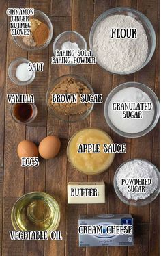 the ingredients to make an apple pie are shown in bowls on a wooden table, including flour, sugar, butter, and eggs