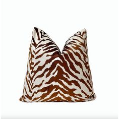 a brown and white zebra print pillow on a white background