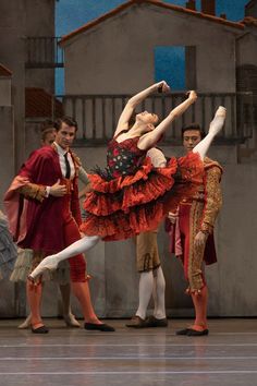 the ballerinas are dressed in red and gold