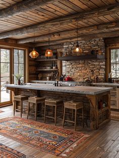 a rustic kitchen with an island in the middle and lots of wood flooring on the walls