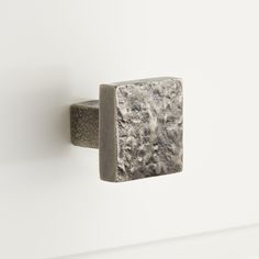 a close up of a metal object on a white wall with no people around it