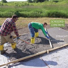 two men working together to build a concrete walkway