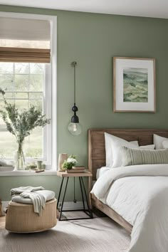 a bedroom with green walls and white bedding